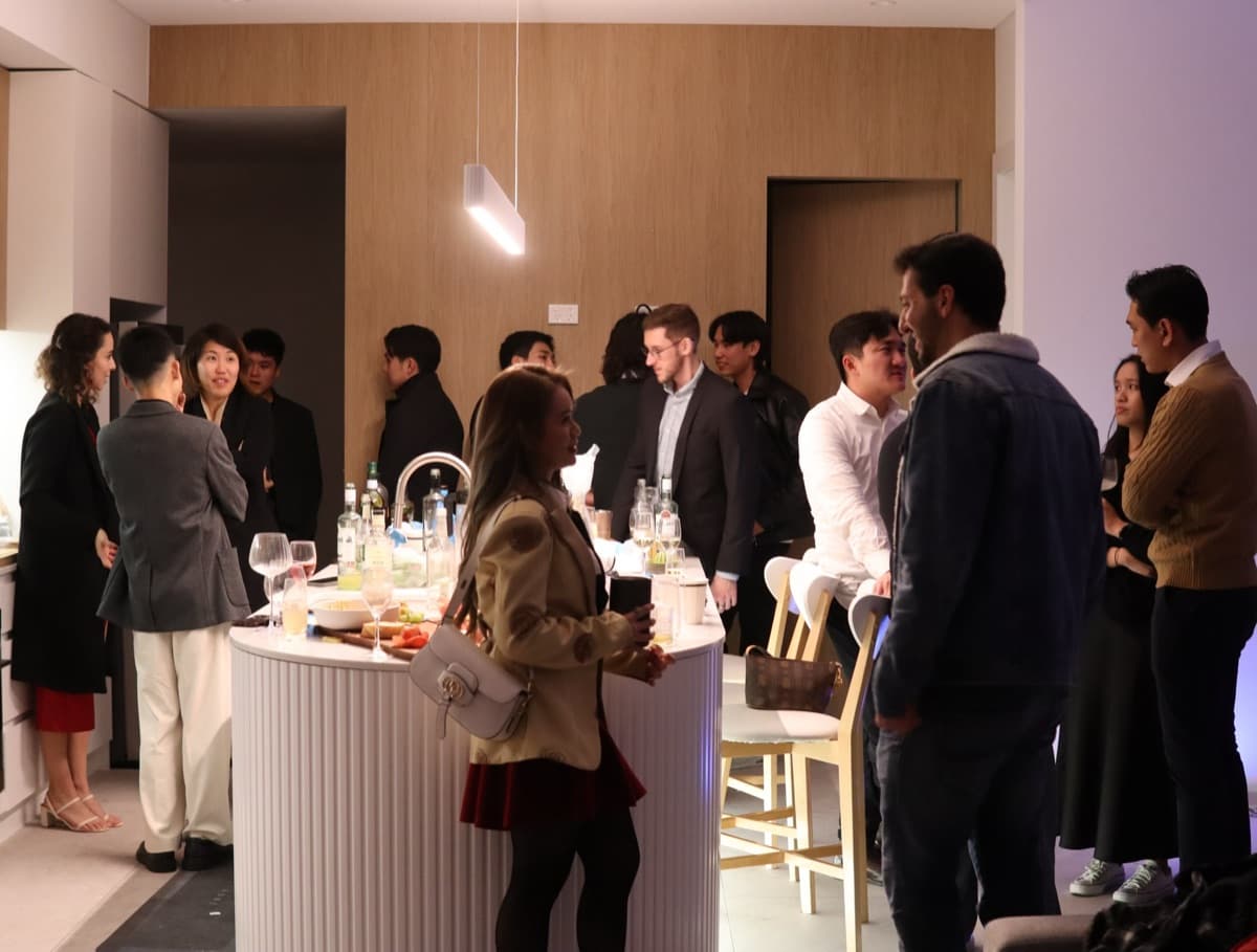 Community networking event — diverse professionals connecting through English